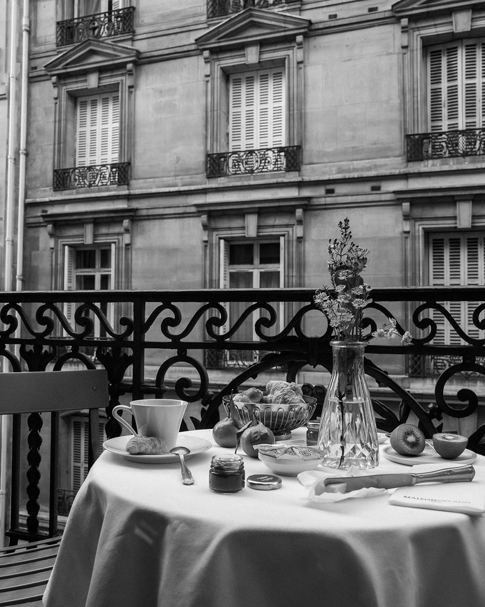 A set dining table on a balcony in Paris