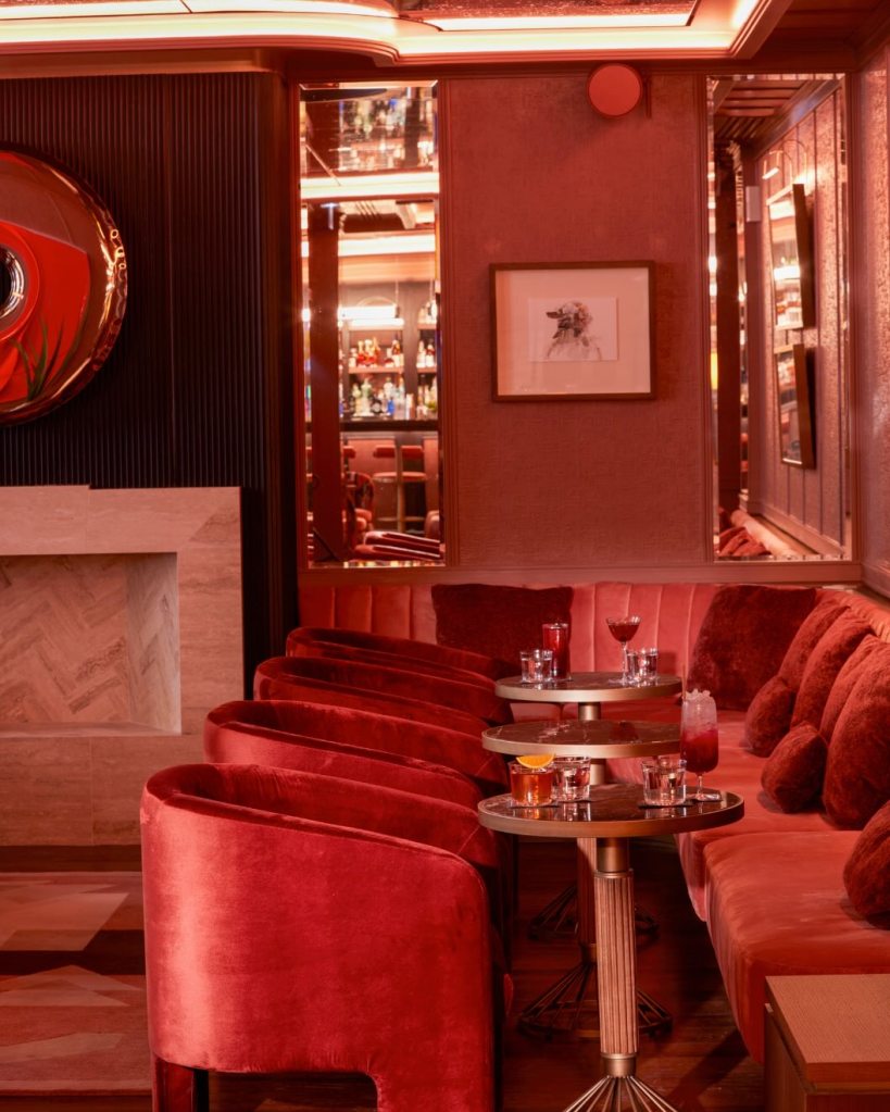 the rose colored bar that is the delano bar with red walls and seating