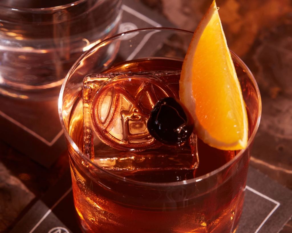 an old fashioned garnished with an orange slice