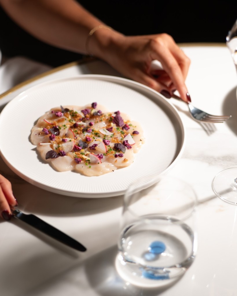 a beautifully plated dish on a marble table