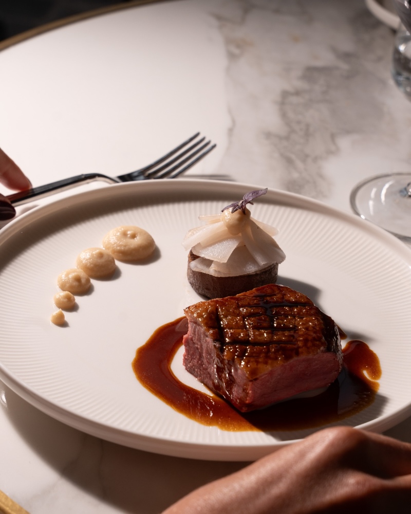 a beautifully plated steak at delano cafe by thierry marx