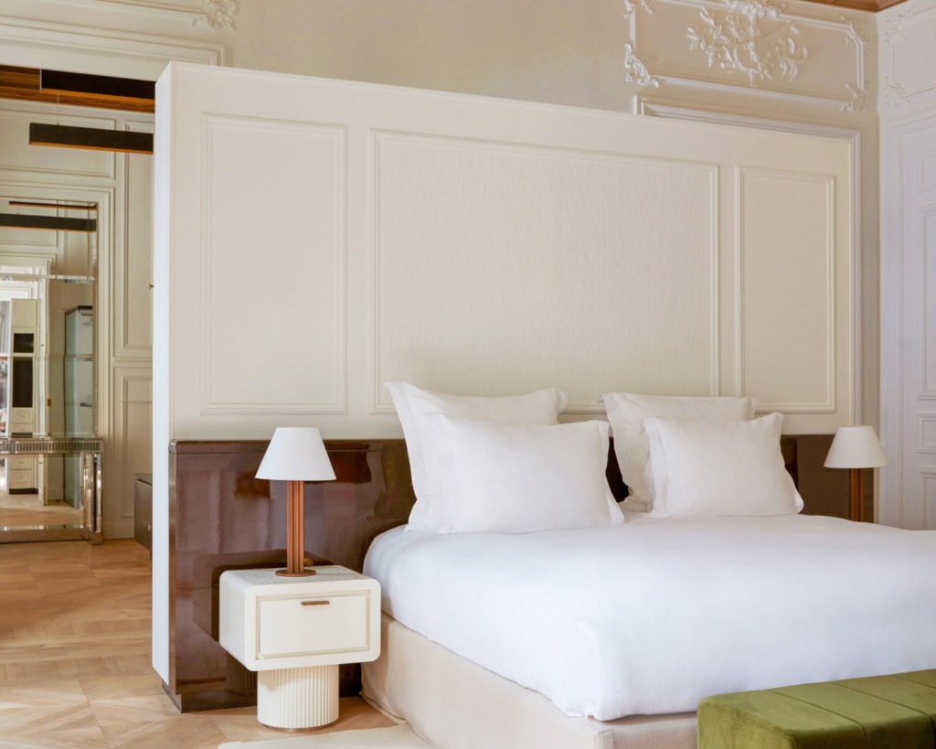 an ornate bedroom with a false wall, in the historic suite