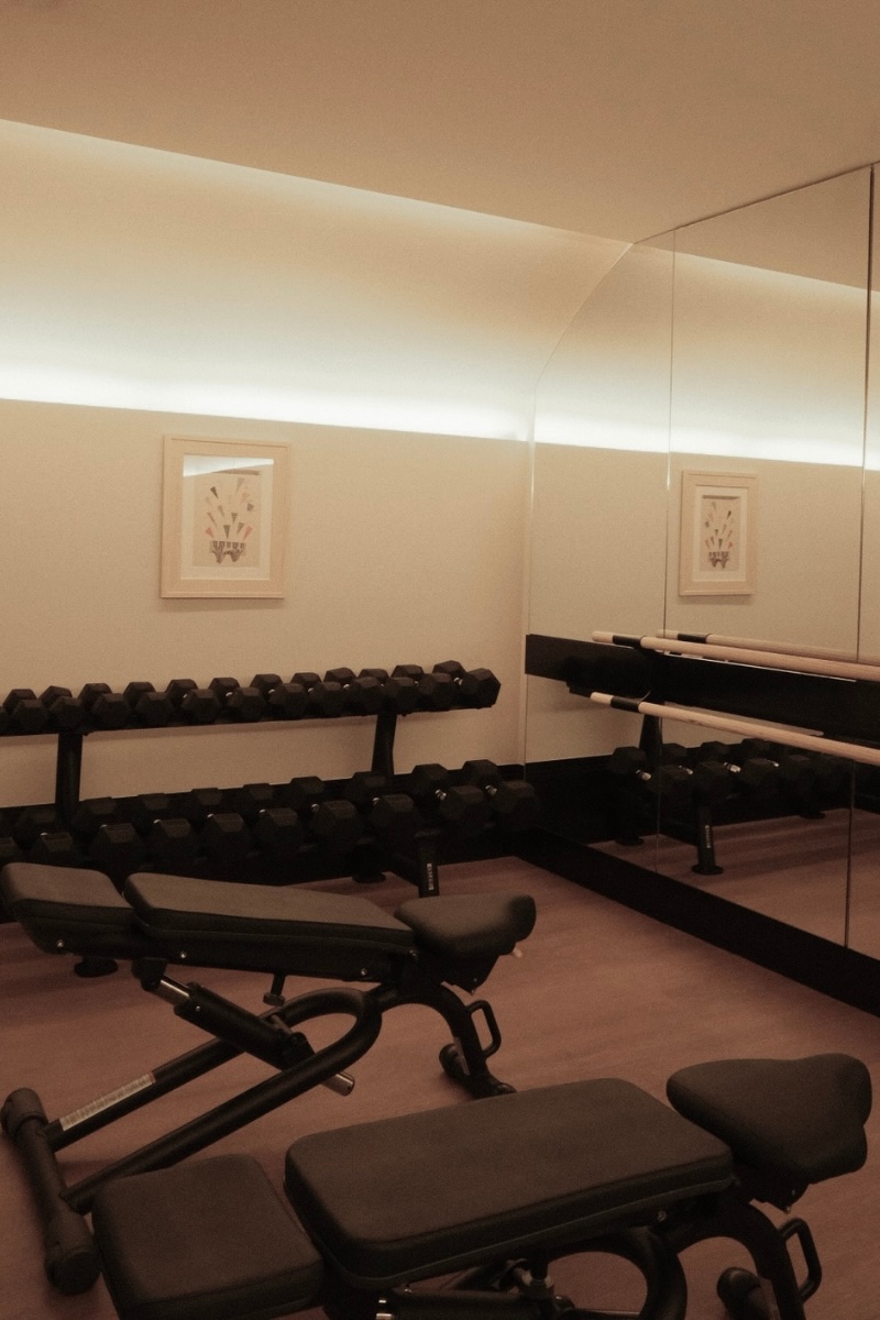 benches and weights in the fitness center at maison delano paris