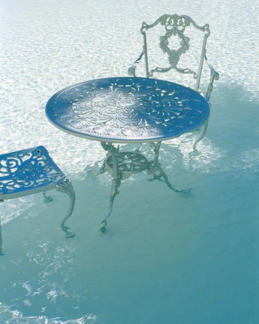 silver chairs and table in a pool at the original delano south beach