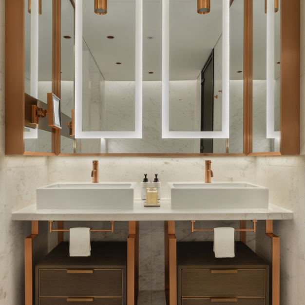 a bathroom vanity with 2 sinks and a large wall mirror