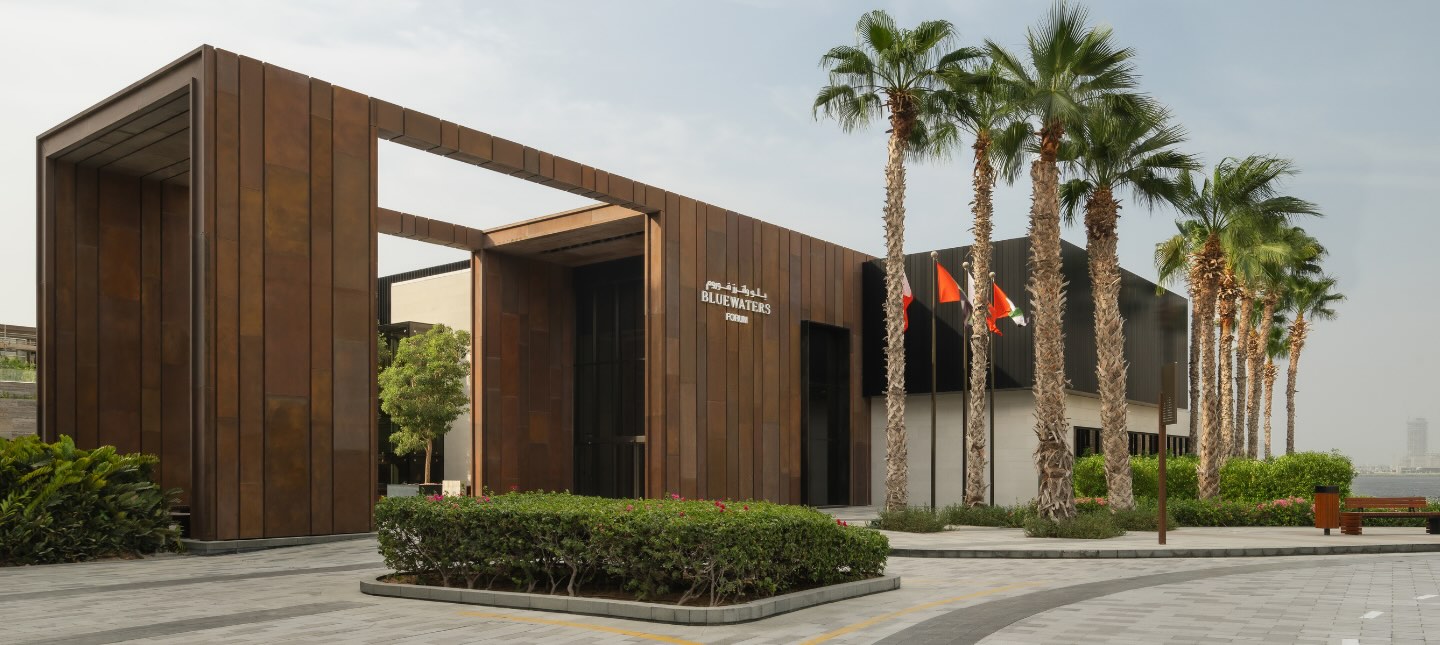 the outside of the delano convention center with palm trees lining the building