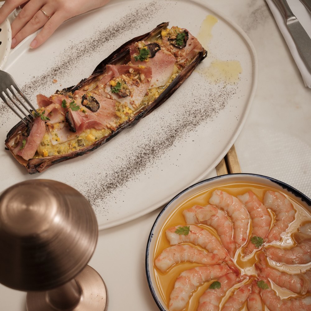 mediterranean dishes served on plates on a white linen table