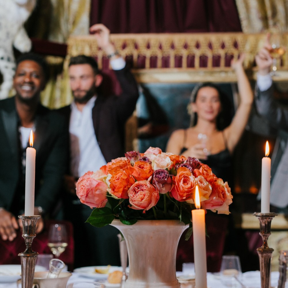 a group enjoying their time at maison revka with their hands in the air