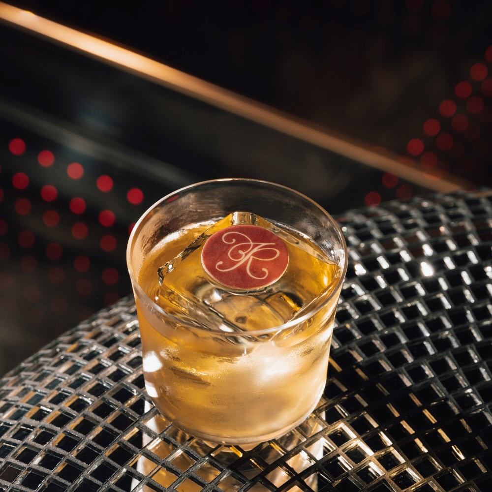 a cocktail placed on a reflective table