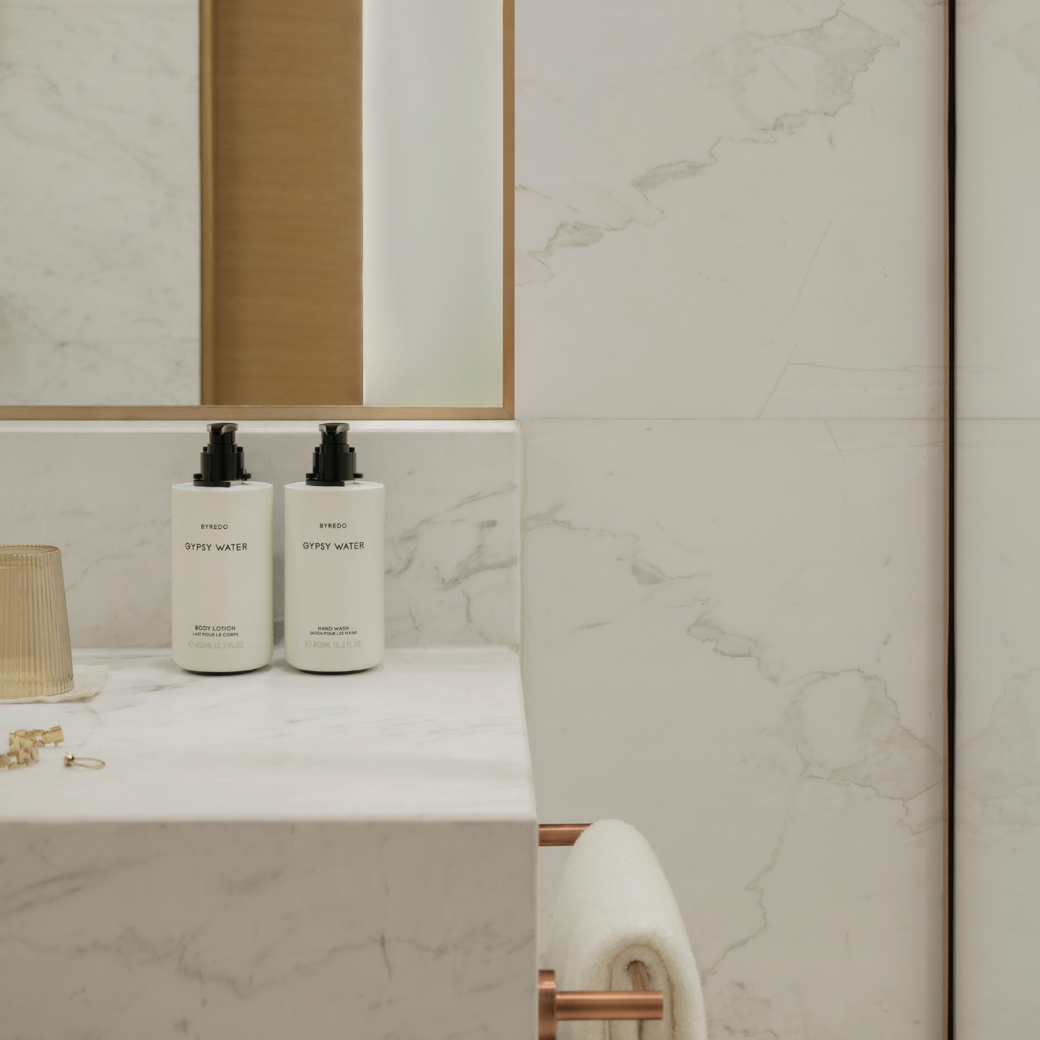 bath amenities sitting atop a marble counter in the batrhoom