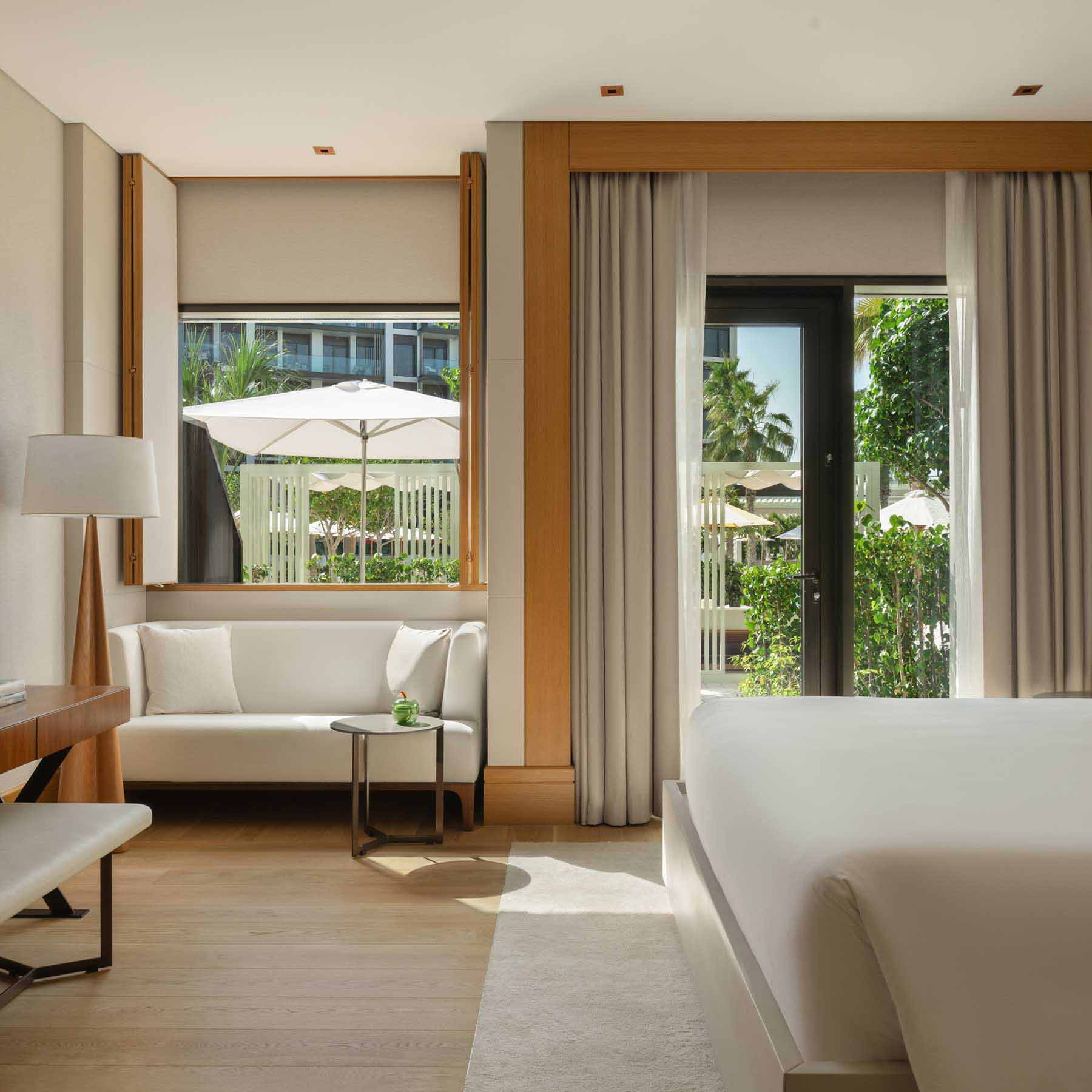 the rising light garden room with a king bed and seating area with natural light and views of the garden space