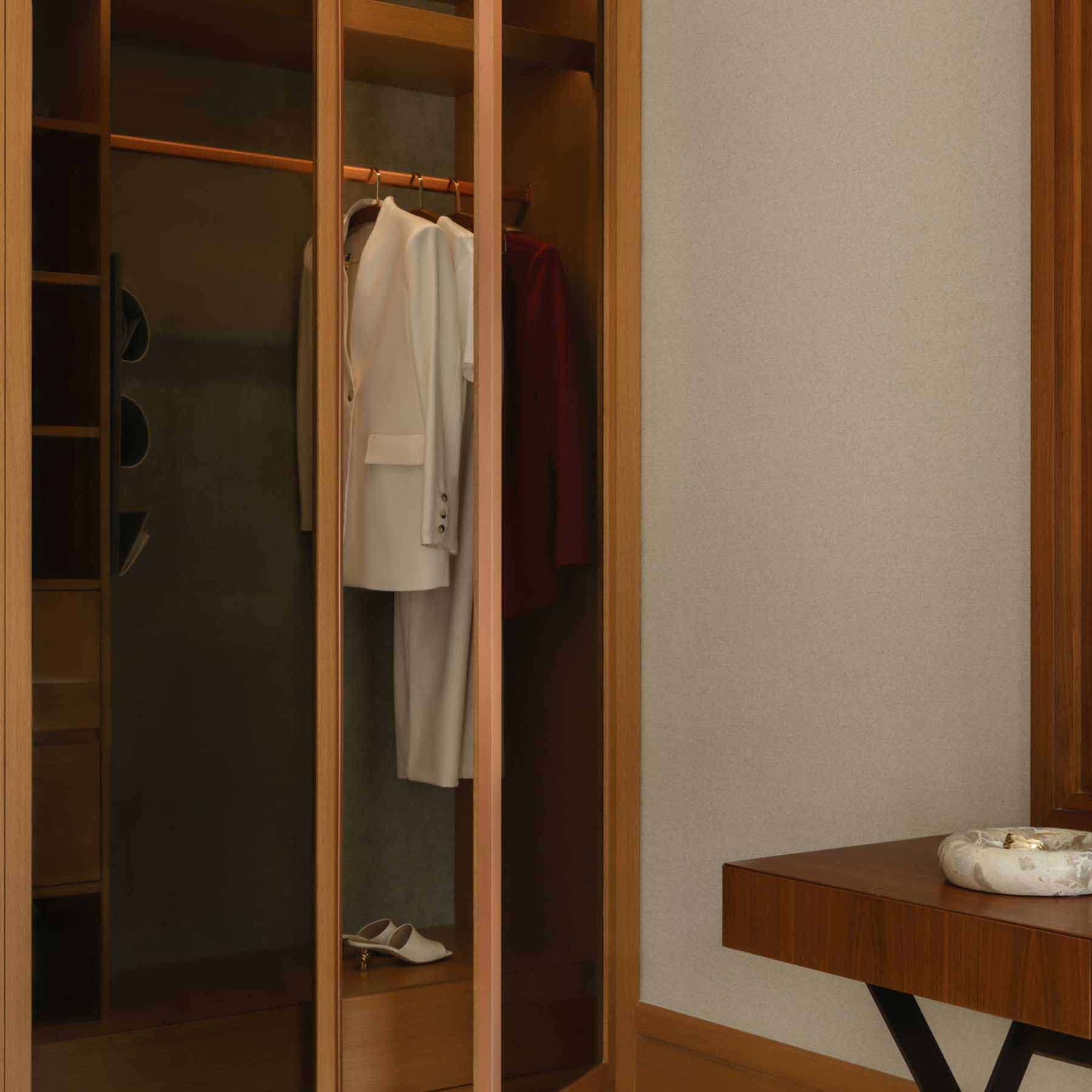 the closet space with hanging robes