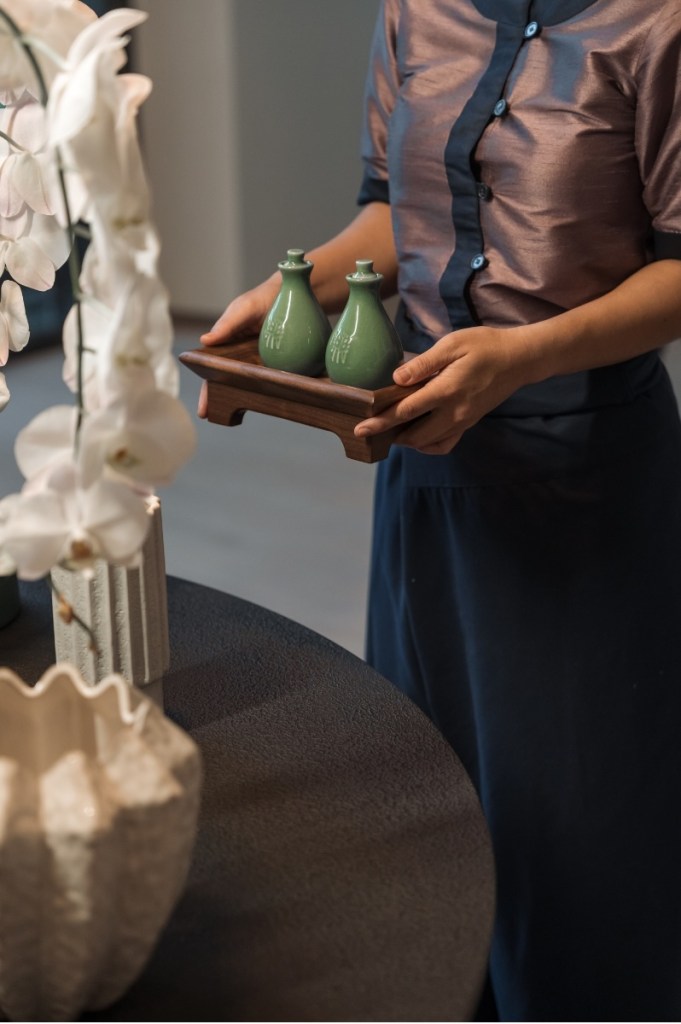 a woman walking with the ceramic oil diffusers for a treatment