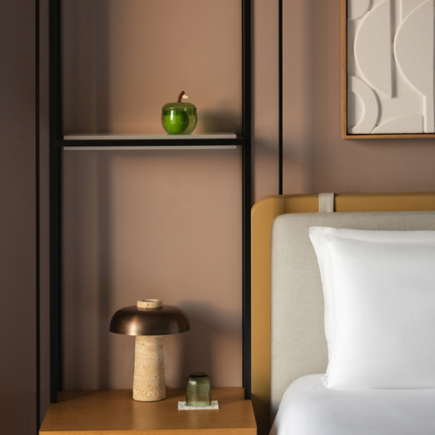 a detailed shot of the bedside table with an apple and small lamp