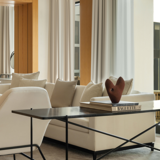 a side table behind a white chair in the living space