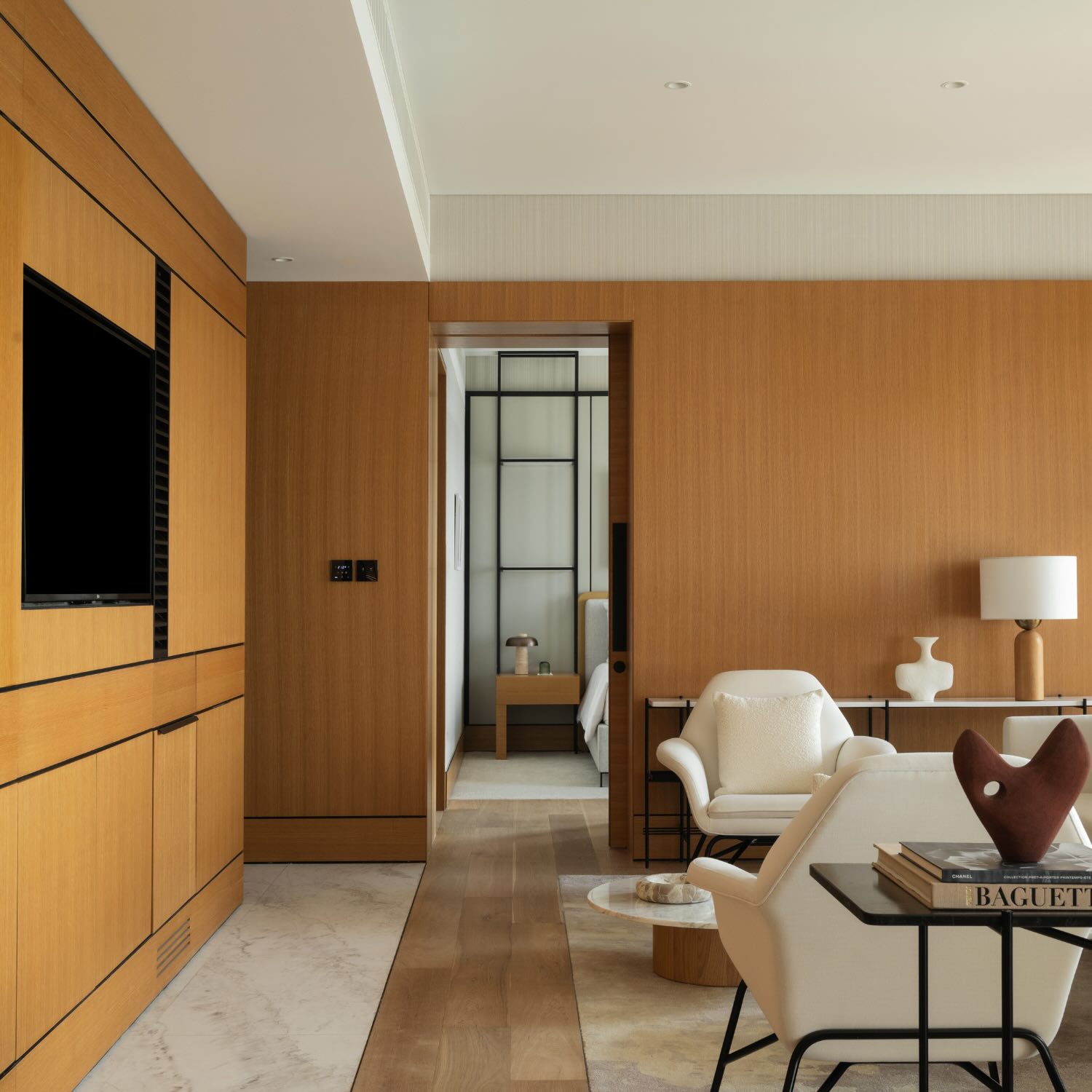 a view into the bedroom from the living area with an hdtv in the wall