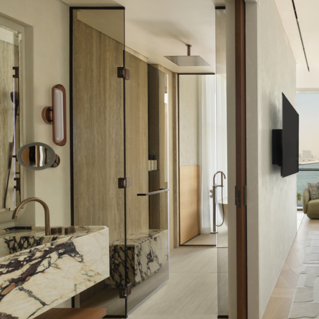 a bathroom with a rainfall shower and marble vanity