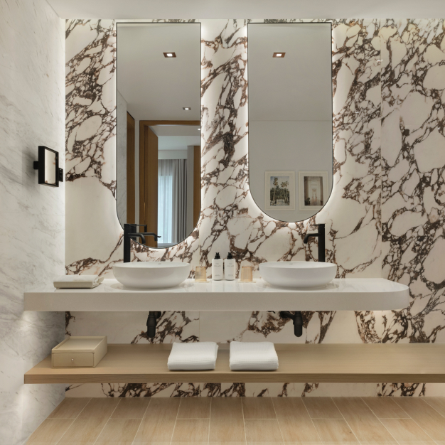 an intricate marble bathroom with 2 sinks