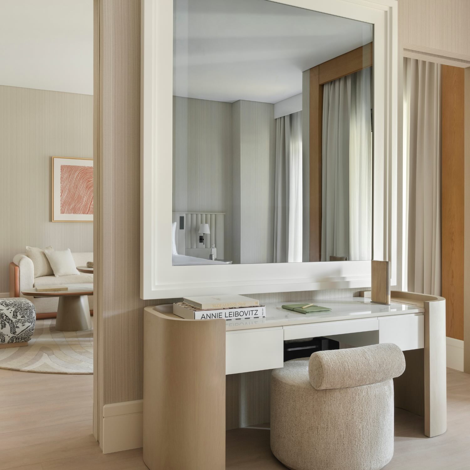 a vanity or desk in the bedroom showcasing the sliding glass doors that lead you outside and a look into the living room