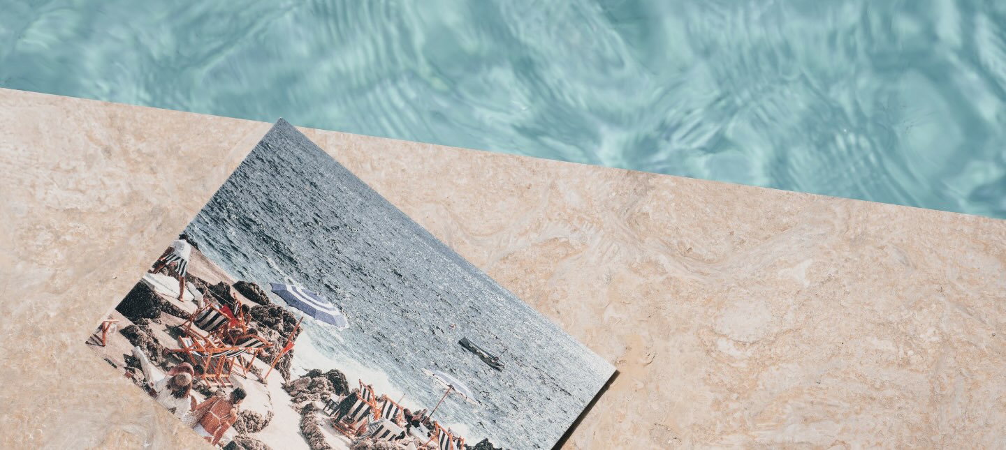 a postcard with an image of the amalfi coast next to a bright pool