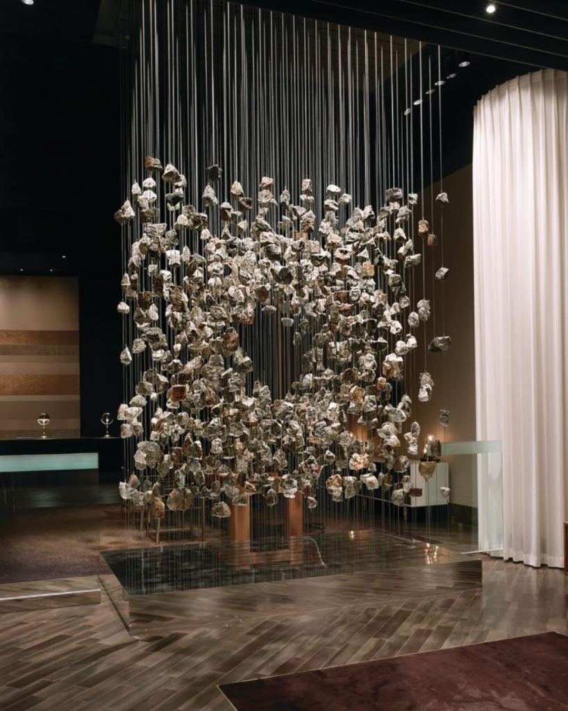 an elevated art installation of rocks hanging from the ceiling