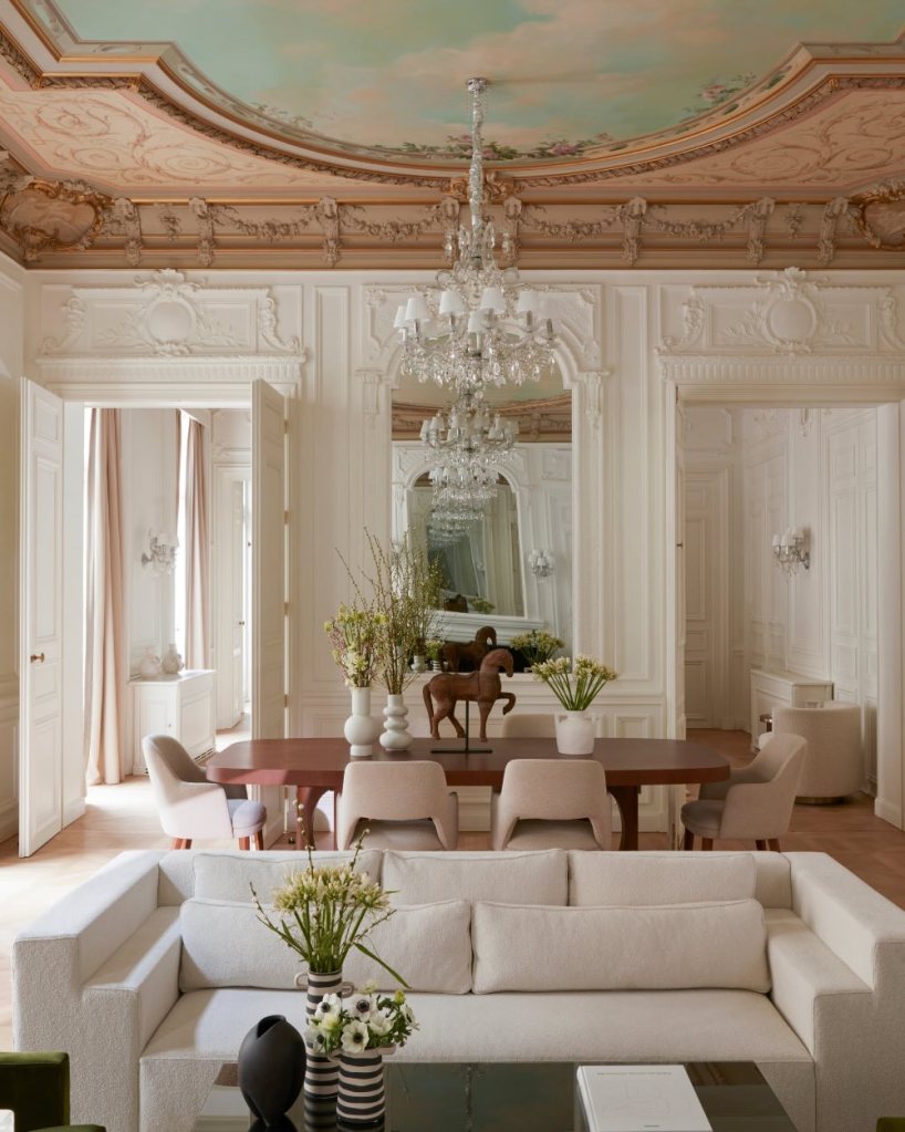 a beautiful historic suite at maison delano paris with crown moldings and glass chandeliers