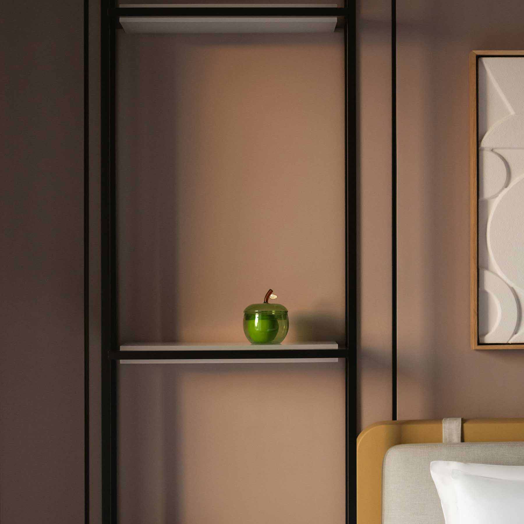 a detailed shot of the bedside table with an apple and small lamp