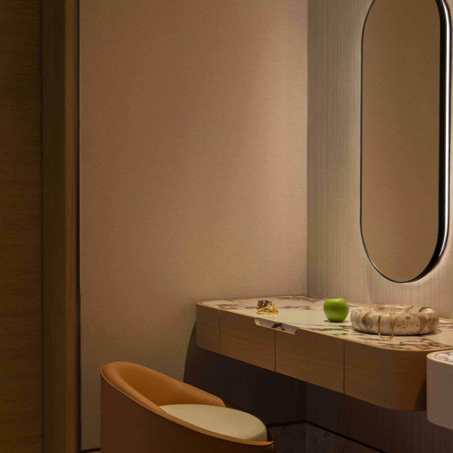 a vanity in the bathroom with dim lighting and plenty of counter space