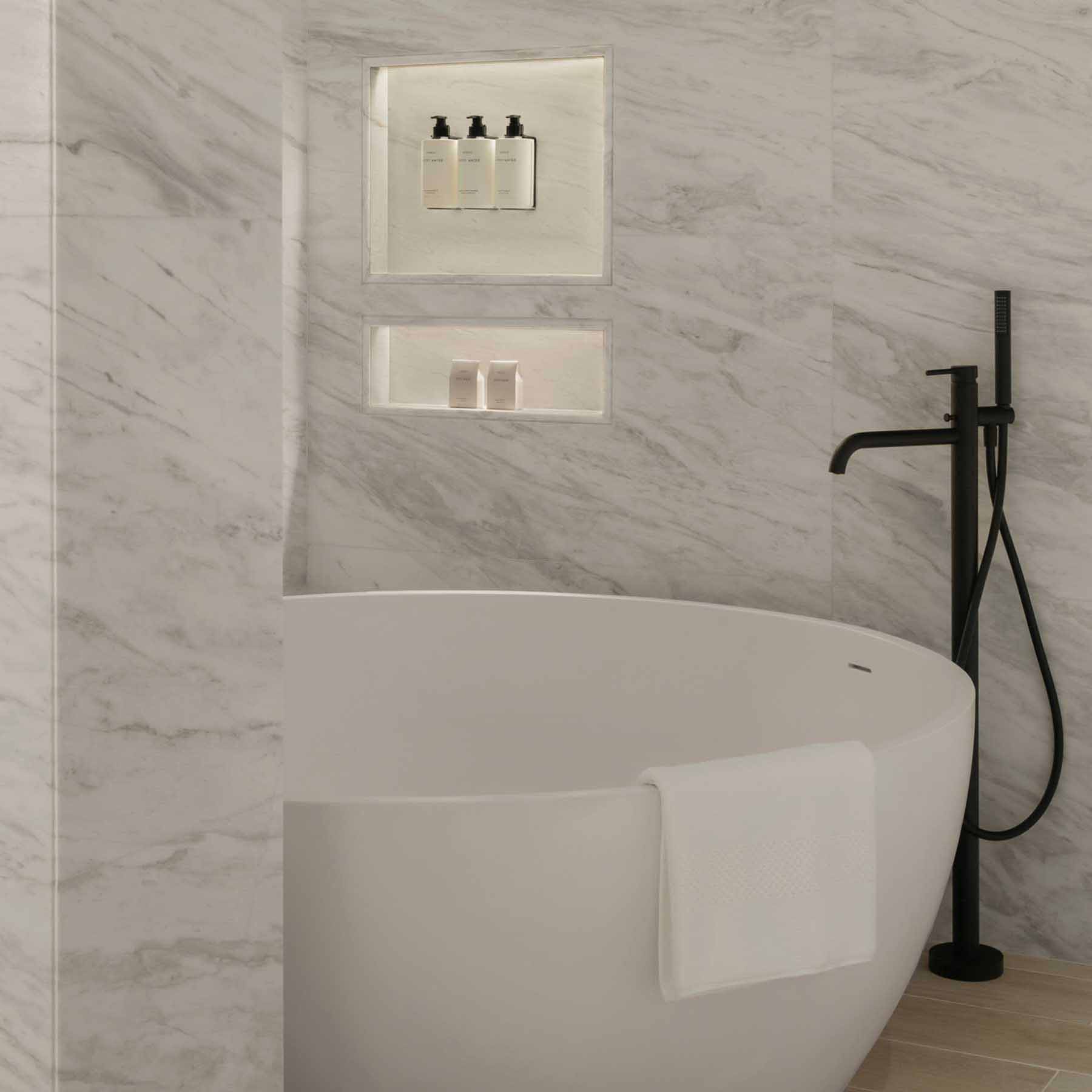 a large bathtub with luxurious bath amenities available