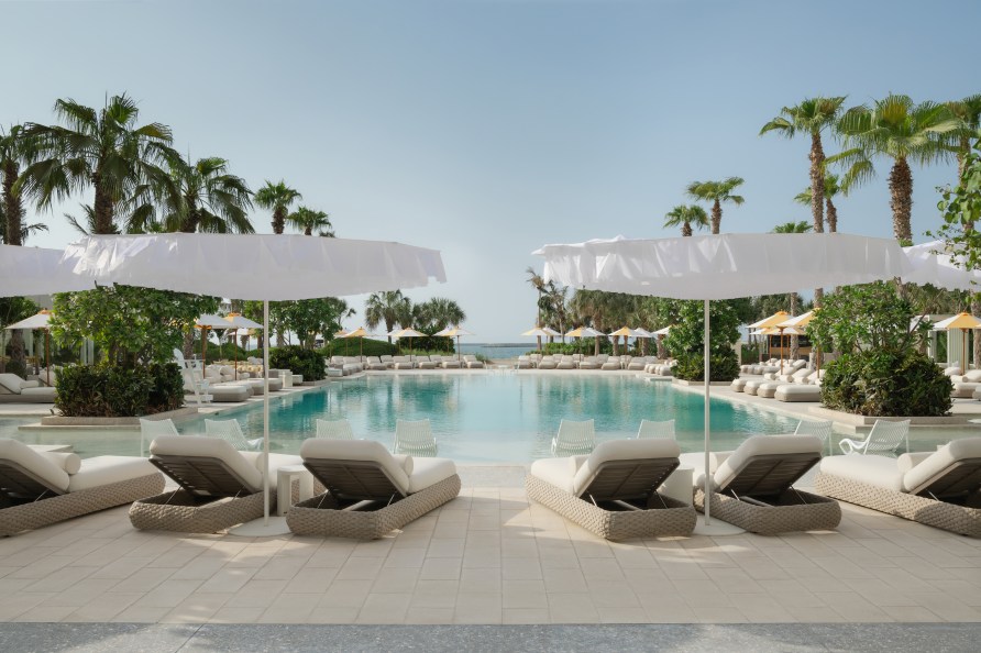 Cabanas, sun loungers, sparkling pool, beachfront at Delano Dubai